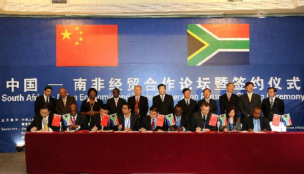 Jia Qinglin (C Back), chairman of the National Committee of the Chinese People's Political Consultative Conference, attends the signing ceremony of a package of deals on Chinese enterprises' purchasing products worth more than 300 million U.S. dollars from South Africa, in Pretoria, South Africa, March 31, 2010.