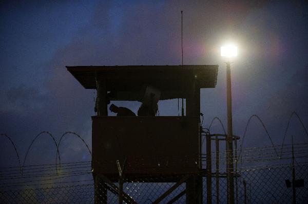 In this photo, a guard tower is pictured in front of the Guantanamo detention facility, at Guantanamo Bay U.S. Naval Base, Cuba, Tuesday, March 30, 2010. The Obama Administration is pushing to close the Guantanamo detention facility, by transferring, prosecuting, or releasing the remaining detainees. [Xinhua/AFP]