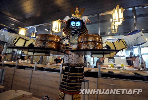 A robot waiter serves food to customers at Hajime Japanese restaurant in Bangkok April 1, 2010. Restaurant owner Lapassarad Thanaphant said she spent 30 million baht (US$927,600) on the Japanese restaurant including the purchase of four robots from Japan. [Xinhua/Reuters]