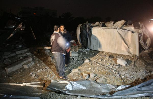 Palestinian inspect the site of a destroyed factory after an Israeli airstrike in Gaza City. [Xinhua] 