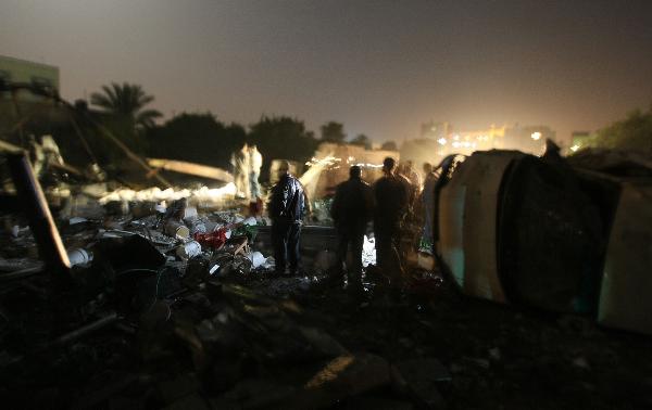 Palestinian inspect the site of a destroyed factory after an Israeli airstrike in Gaza City. [Xinhua]