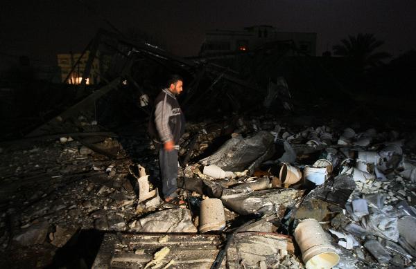 Palestinian inspect the site of a destroyed factory after an Israeli airstrike in Gaza City. [Xinhua]