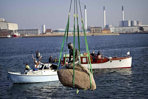 The Little Mermaid sculpture on her rock is hoisted from its place in the waterline at Langelinie in Copenhagen, March 25, 2010, to be transported to the World Expo 2010 exhibition in Shanghai. 