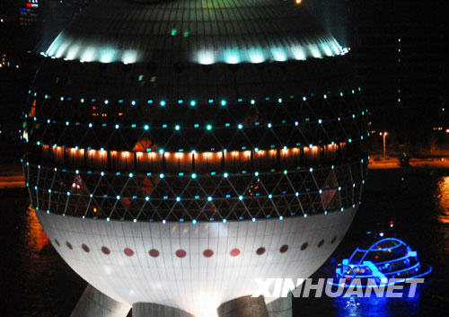 The Oriental Pearl TV Tower, a symbolic architecture of Shanghai, looks charming at night. [Xinhua Photo] 