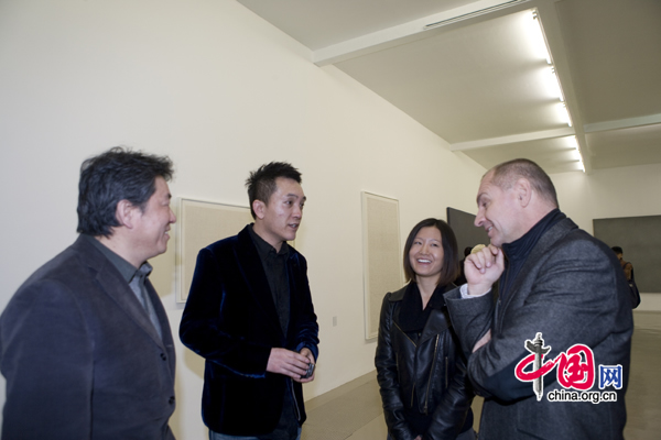 Owner and curator Wang Xinyou, second from left, talks with visitors.