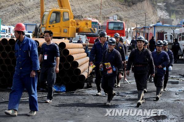 Rescuers walk to the flooded Wangjialing Coal Mine in north China's Shanxi Province again after continuously working for more than 10 hours underground early on April 6, 2010. 