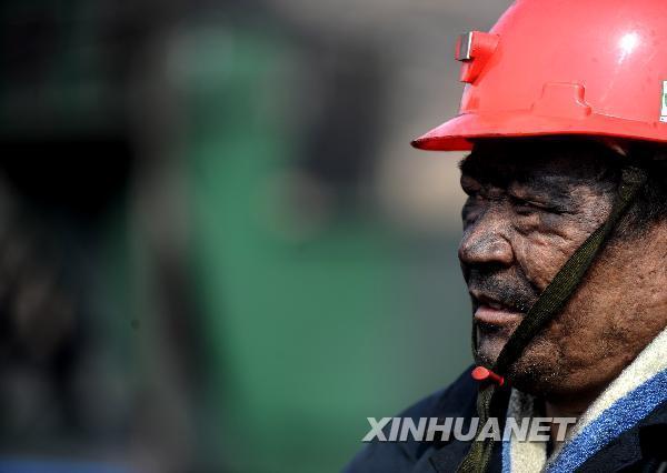 A rescuer walk out of the flooded Wangjialing Coal Mine in north China's Shanxi Province after continuously working for more than 10 hours underground, early on April 6, 2010. 