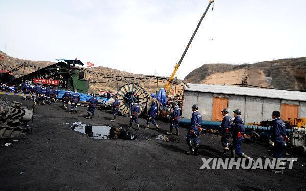 Rescuers walk to the flooded Wangjialing Coal Mine in north China's Shanxi Province again after continuously working for more than 10 hours underground early on April 6, 2010. 