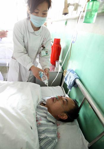 A rescued worker receives medical treatment in a hospital in Hejin City, north China's Shanxi Province, on April 6.