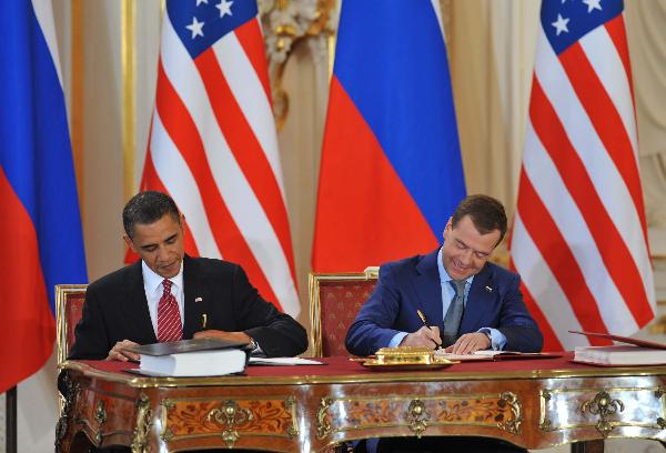 U.S. President Barack Obama (L) and his Russian counterpart Dmitry Medvedev sign a landmark nuclear arms reduction treaty in Prague, capital of Czech Republic on April 8, 2010. [Xinhua]
