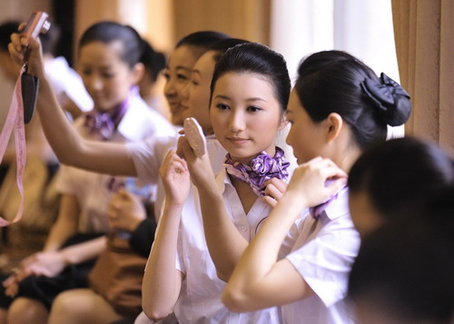 Competitors put on make-up before the Air Hostess Contest TV show in Wuhan, capital of Central China&apos;s Hubei province on April 7, 2010.[Photo/Xinhua]