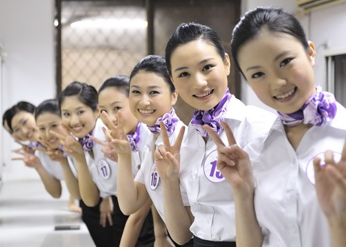 Competitors pose backstage before the Air Hostess Contest TV show in Wuhan, capital of Central China&apos;s Hubei province on April 7, 2010.[Photo/Xinhua]