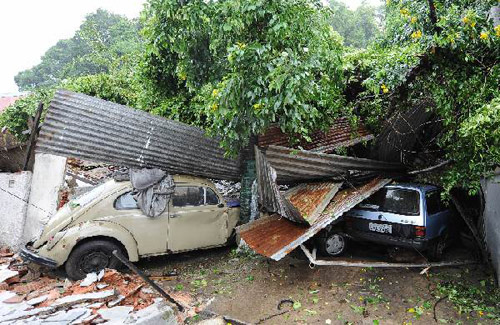 Cars are damaged after a landslide hit the neighbourhood of Ilha Governador in Rio de Janiero. [Xinhua/AFP]