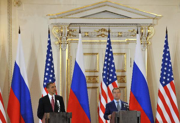 U.S. President Barack Obama (L) and his Russian counterpart Dmitry Medvedev attend a news conference after signing a landmark nuclear arms reduction treaty in Prague, capital of Czech Republic, on April 8, 2010. Under the new pact, the two countries agreed to reduce their deployed nuclear warheads to 1,550 each, or 30 percent below the current level of 2,200, and cut the launchers below 700 each.[Wu Wei/Xinhua]