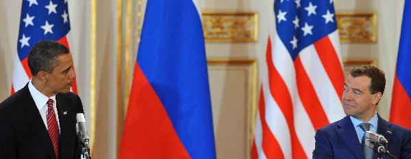 U.S. President Barack Obama (L) and his Russian counterpart Dmitry Medvedev attend a news conference after signing a landmark nuclear arms reduction treaty in Prague, capital of Czech Republic, on April 8, 2010. Under the new pact, the two countries agreed to reduce their deployed nuclear warheads to 1,550 each, or 30 percent below the current level of 2,200, and cut the launchers below 700 each.[Wu Wei/Xinhua]