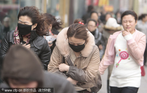 People walk in the severe gales in Changchun, capital of Jilin province, April 8, 2010. [CFP]