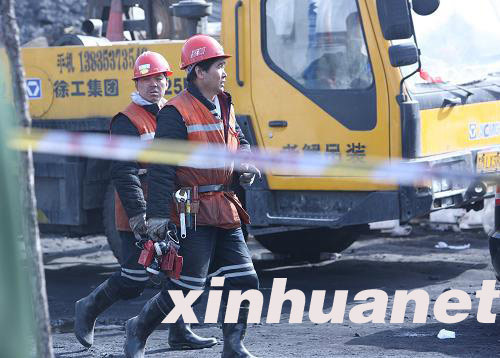 The death toll at the flooded Wangjialing Coal Mine in north China's Shanxi Province had risen to 20 as of 8:20 p.m. Thursday while 18 miners are still unaccounted for, rescue authorities said. In the picture taken on April 8, rescue workers walk out of the coal mine.