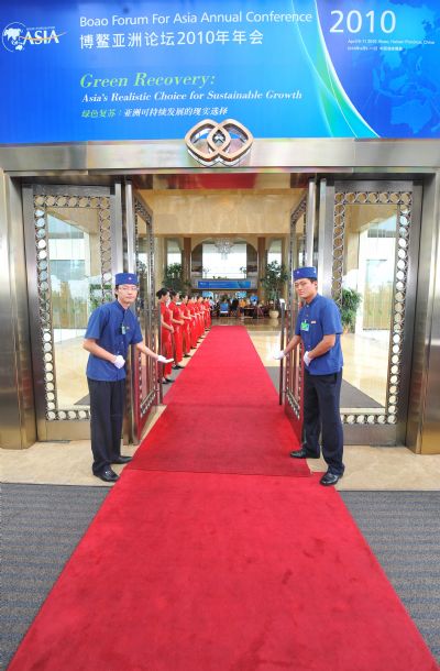 Staff members welcome guests at the conference hall for the Boao Forum for Asia (BFA) 2010 in Boao, a scenic town in south China's Hainan Province, April 8, 2010. BFA 2010 meeting will be held from April 9 to 11.