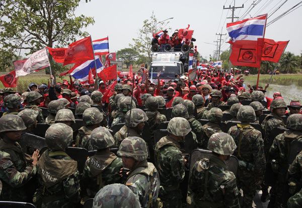 Anti-government &apos;red shirt&apos; protesters fight with army soldiers at Thaicom Teleport on the outskirts of Bangkok in Pathum Thani province April 9, 2010. [Xinhua] 