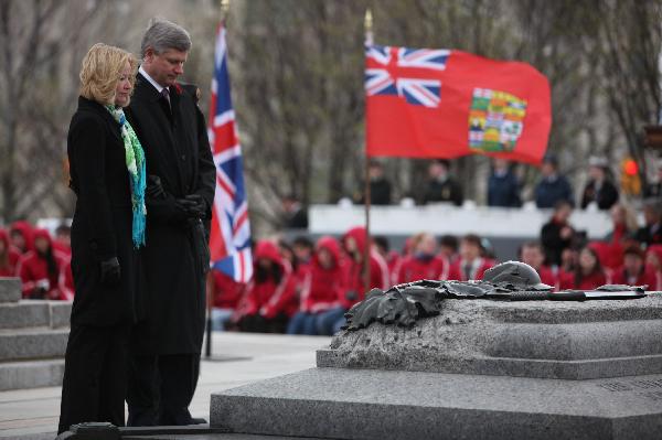 Canadian Prime Minister Stephen Harper and his wife mourns at the Vimy Ridge Day commemoration at Ottawa, capital of Canada, April 9, 2010. Canada held a grand ceremony at the National War Memorial in Ottawa on Friday, officially marked the end of an era as the country's last known World War I veteran John Babcock was gone earlier.