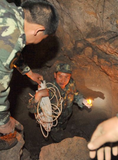 A group of local militiamen explore in a Karst Cave in Longlin County, southwest China's Guangxi Zhuang Autonomous Region, April 10, 2010. The group of local militiaman tried to find new water source from a Karst Cave due to the drought.