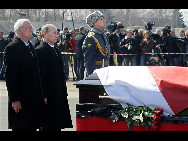 Russian Prime Minister Vladimir Putin (R) and Polish Ambasador in Moscow Jerzy Bahr pay their respects to Polish President Lech Kaczynski during a farewell ceremony at the airport of Smolensk April 11, 2010. [Xinhua]