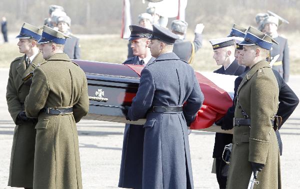 Polish servicemen carry a coffin with Polish President Lech Kaczynski during a farewell ceremony at the Smolensk airport April 11, 2010. Poles were in deep mourning on Sunday after President Lech Kaczynski and many of the country&apos;s ruling elite were killed in a plane crash.[Xinhua]