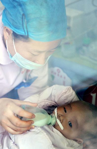 A nurse takes care of a baby at an ICU room in Chenzhou Children&apos;s Hospital affiliated to Chenzhou First People&apos;s Hospital in Chenzhou, central China&apos;s Hunan Province, April 11, 2010. 