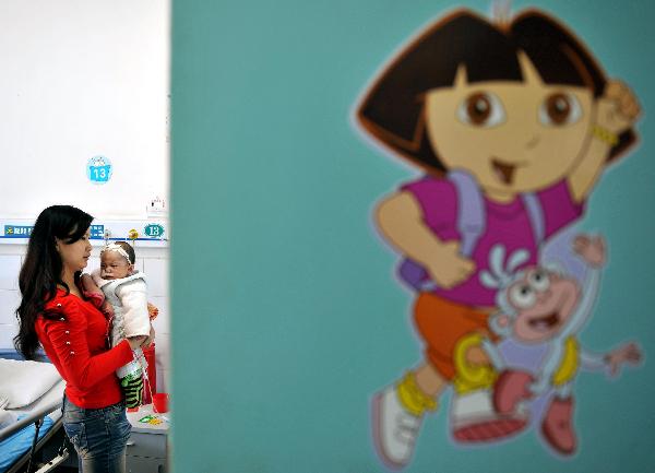  A woman holds her baby in Chenzhou Children&apos;s Hospital affiliated to Chenzhou First People&apos;s Hospital in Chenzhou, central China&apos;s Hunan Province, April 11, 2010. 