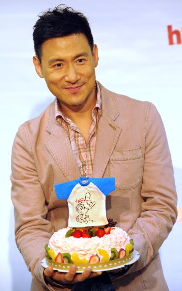 Jacky Cheung, a Hong Kong pop music star singer, holds the cake presented by the song fans, during the fans club meeting marking his new album release, in Taipei, southeast China's Taiwan, April 12, 2010. Jacky Cheung joins in a fans club meeting with Taipei fans on promotion of his new albums of Cantonese pop song with titles of Private Corner, and interacts with fans.