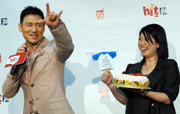 Jacky Cheung, a Hong Kong pop music star singer, holds the cake presented by the song fans, during the fans club meeting marking his new album release, in Taipei, southeast China's Taiwan, April 12, 2010. Jacky Cheung joins in a fans club meeting with Taipei fans on promotion of his new albums of Cantonese pop song with titles of Private Corner, and interacts with fans.