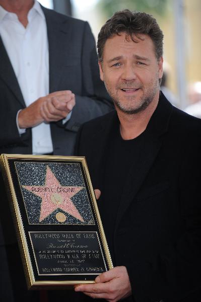 Actor Russell Crowe holds his plaque at the ceremony where he was honored with a star on the Walk of Fame in Hollywood, California April 12, 2010.