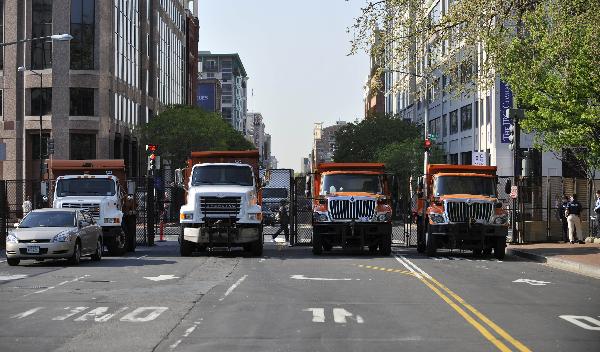 Trucks block the road outside the Washington Convention Center prior to the Nuclear Security Summit in Washington, capital of the United States, April 12, 2010. [Zhang Jun/Xinhua] 