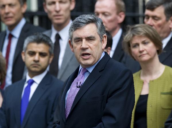 Britain's Prime Minister Gordon Brown (C), surrounded by his Cabinet members, announces a general election for May 6 at 10 Downing Street in London April 6, 2010.[Xinhua]