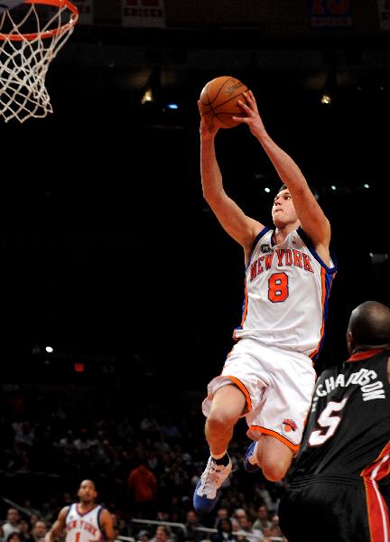 Danilo Gallinari (Top) of New York Knicks goes up for a shoot during their NBA basketball game against Miami Heat at Madison Square Garden in New York April 11, 2010. Heats won 111-98. (Xinhua/Shen Hong)(