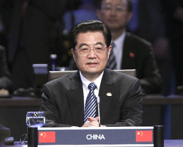 Chinese President Hu Jintao attends the first plenary session of the Nuclear Security Summit at the Washington Convention Center in Washington, April 13, 2010. [Ju Peng/Xinhua]