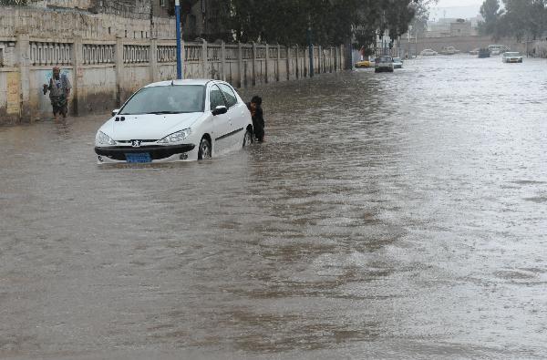 A car suffers engine failure on a flooded street in Sanaa, capital of Yemen, April 14, 2010. A heavy rain hit the low rainfall Sanaa on Wednesday, causing flooding on the streets.
