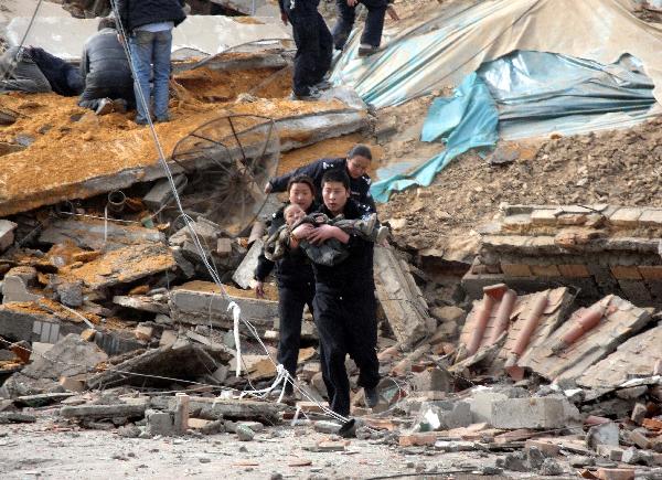 Police and people succor a child from the debris of crumbled houses shortly after an earthquake jolted at 7:49 a.m., at Gyegu Town, of Yushu, a Tibetan autonomous prefecture in western Qinghai Province of northwest China, April 14, 2010.
