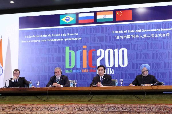 Chinese President Hu Jintao (2nd R) speaks at a joint press conference held together with Brazilian President Luiz Inacio Lula da Silva (2nd L), Russian President Dmitry Medvedev (1st L) and Indian Prime Minister Manmohan Singh (1st R) during the second summit meeting of BRIC (Brazil, Russia, India and China) leaders in Brasilia, capital of Brazil, April 15, 2010. [Liu Weibing/Xinhua] 