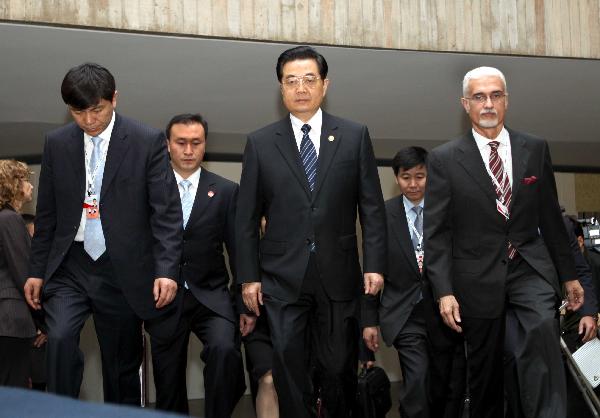 Chinese President Hu Jintao (C, front) walks into the meeting hall of the second summit meeting of BRIC (Brazil, Russia, India and China) leaders in Brasilia, capital of Brazil, April 15, 2010. The second summit meeting of BRIC leaders started on Thursday. [Liu Weibing/Xinhua] 
