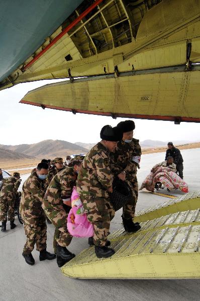 Rescuers from Shenzhen (south China's Guangdong Province) transport injured people to get on the plane at Yushu Airport in the 7.1-magnitude-earthquake-hit Yushu County, northwest China's Qinghai Province, April 15, 2010.