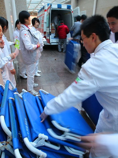 Beijing 999 First Aid medical staff members prepare to leave for quake-hit Yushu April 14, 2010. The first aid center sent 64 medical staffs, 15 first aid vehicles with other medical equipments. 