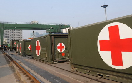 Temporary medical shelters are delivered from Zhengzhou, capital of central China's Henan province to Yushu, the quake-hit area April 15, 2010. The shelters with medical equipments are expected to arrive Xining, capital of Qinghai province on Saturday morning.