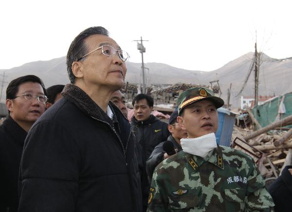 Chinese Premier Wen Jiabao (L Front) inspects quake ruins in Yushu County of northwest China's Qinghai Province, April 15, 2010. Premier Wen continued his visit in quake-hit Yushu County on April 16, and visited quake-devastated schools, orphanages, monasteries and camps for quake-displaced people.