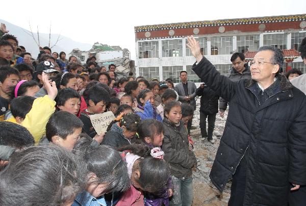 Chinese Premier Wen Jiabao (R) visits orphans in Yushu County of northwest China's Qinghai Province, April 16, 2010. Premier Wen continued his visit in quake-hit Yushu County on Friday, and visited quake-devastated schools, orphanages, monasteries and camps for quake-displaced people. 