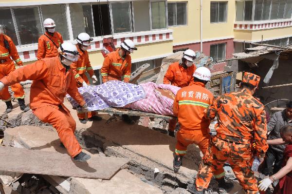 Rescuers help a survivor out of debris in quake-hit Yushu County, Qinghai Province, April 16, 2010. A dragnet serach for survivors is implemented throughly at all rescuing sites as the 'golden 72 hours', a key surviving chance for buried people comes on Friday. Yushu was jolted by a 7.1-magnitude earthquake Wednesday morning, which has left at least 1144 people dead.