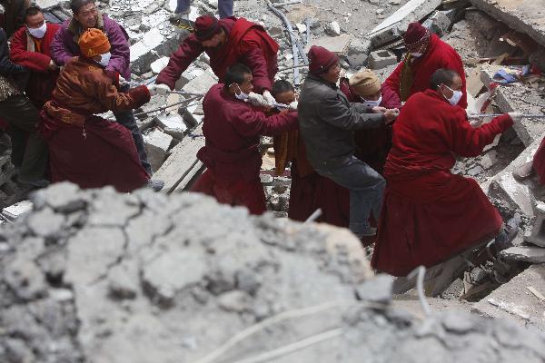 Rescuers work in a sustaining operation of searching for survivors among debris in quake-hit Yushu County, Qinghai Province, April 16, 2010. A dragnet serach for survivors is implemented throughly at all rescuing sites as the 'golden 72 hours', a key surviving chance for buried people comes on Friday. Yushu was jolted by a 7.1-magnitude earthquake Wednesday morning, which has left at least 1144 people dead. 