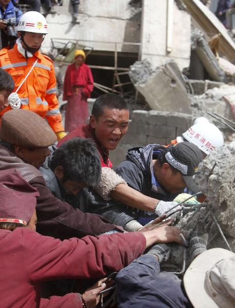 Rescuers work in a sustaining operation of searching for survivors among debris in quake-hit Yushu County, Qinghai Province, April 16, 2010. A dragnet serach for survivors is implemented throughly at all rescuing sites as the 'golden 72 hours', a key surviving chance for buried people comes on Friday. Yushu was jolted by a 7.1-magnitude earthquake Wednesday morning, which has left at least 1,144 people dead. 