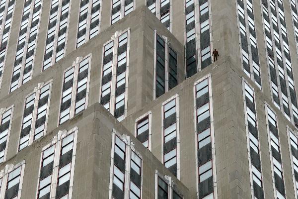 A life-size sculpture by British artist Antony Gormley is placed on the Empire State Building in New York, the United States, April 16, 2010. Thirty one life-size sculptures by British artist Antony Gormley are installed on sidewalks and rooftops of buildings near the Empire State Building as an art display called 'Event Horizon'. 