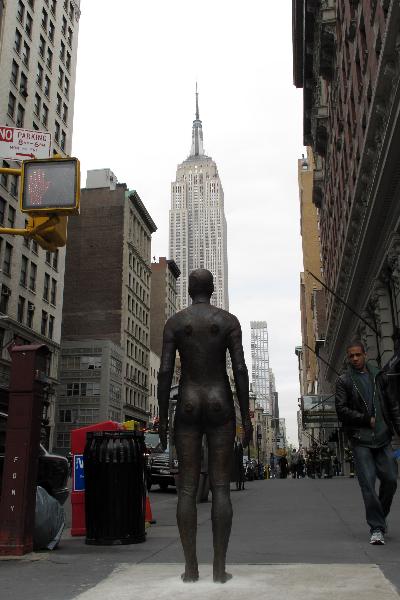 A life-size sculpture by British artist Antony Gormley is placed on a street near the Empire State Building in New York, the United States, April 16, 2010. Thirty one life-size sculptures by British artist Antony Gormley are installed on sidewalks and rooftops of buildings near the Empire State Building as an art display called 'Event Horizon'.